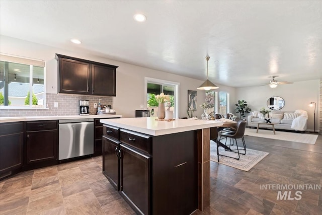 kitchen with stainless steel dishwasher, open floor plan, light countertops, dark brown cabinetry, and decorative backsplash