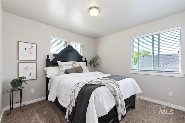 bedroom featuring carpet and baseboards