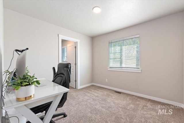 office area with light colored carpet and baseboards