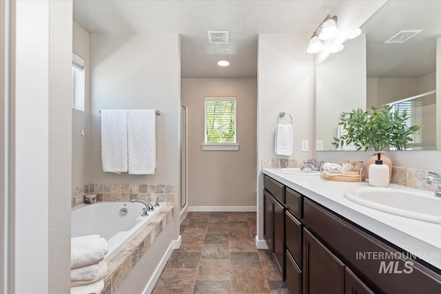 full bathroom with baseboards, a stall shower, and a bath