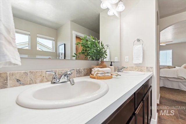 ensuite bathroom featuring healthy amount of natural light and double vanity