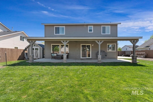 rear view of property featuring outdoor lounge area, a storage unit, a patio, and an outbuilding