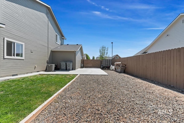 view of yard with a gate, a patio, and central AC
