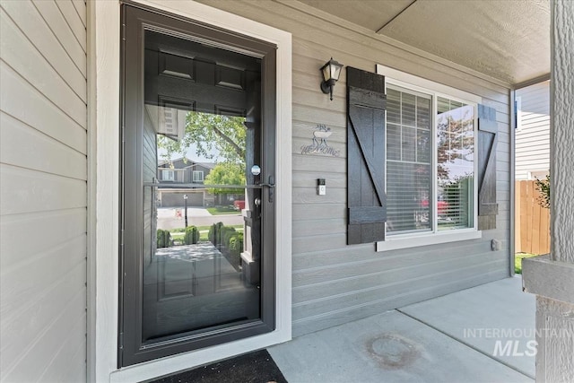 view of exterior entry featuring a porch