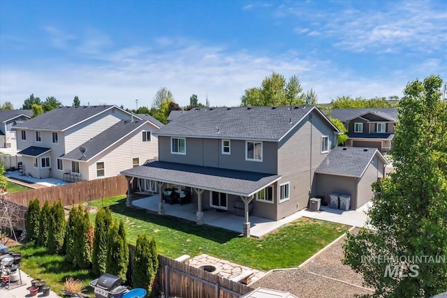 rear view of property featuring a residential view, a patio area, a shingled roof, and cooling unit