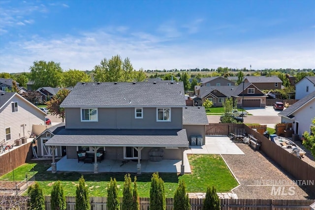 back of house featuring a residential view, a patio area, and roof with shingles