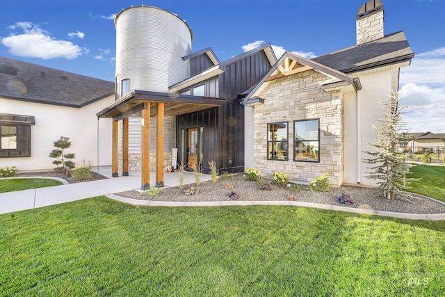 1580 Clear Creek Loop, Twin Falls, ID 83301 - rear view of house featuring stone siding, a lawn, a chimney, and board and batten siding