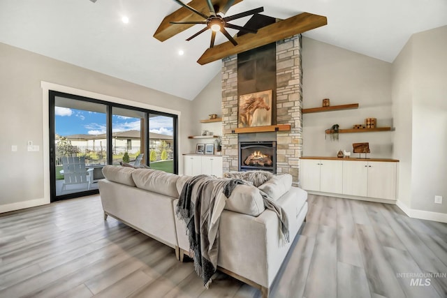 1580 Clear Creek Loop, Twin Falls, ID 83301 - living room with a ceiling fan, light wood finished floors, baseboards, a stone fireplace, and high vaulted ceiling