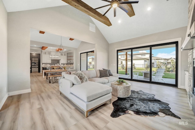 1580 Clear Creek Loop, Twin Falls, ID 83301 - living area featuring a ceiling fan, beam ceiling, light wood-style flooring, high vaulted ceiling, and baseboards