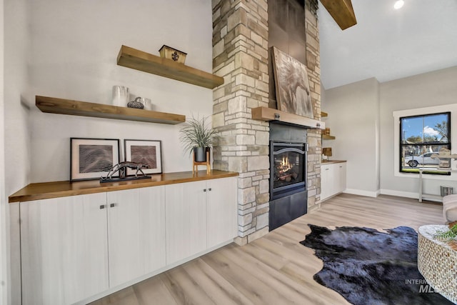1580 Clear Creek Loop, Twin Falls, ID 83301 - living room with a fireplace, light wood-type flooring, baseboards, high vaulted ceiling, and beam ceiling