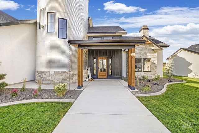 1580 Clear Creek Loop, Twin Falls, ID 83301 - view of exterior entry with stone siding, a yard, and a chimney