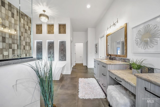 1580 Clear Creek Loop, Twin Falls, ID 83301 - full bathroom featuring a freestanding tub, vanity, tile patterned floors, and a chandelier