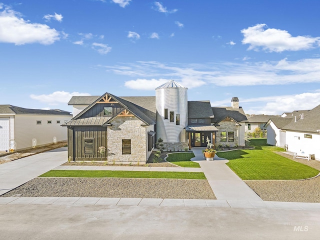 1580 Clear Creek Loop, Twin Falls, ID 83301 - view of front of house with stone siding, board and batten siding, a standing seam roof, a front yard, and metal roof