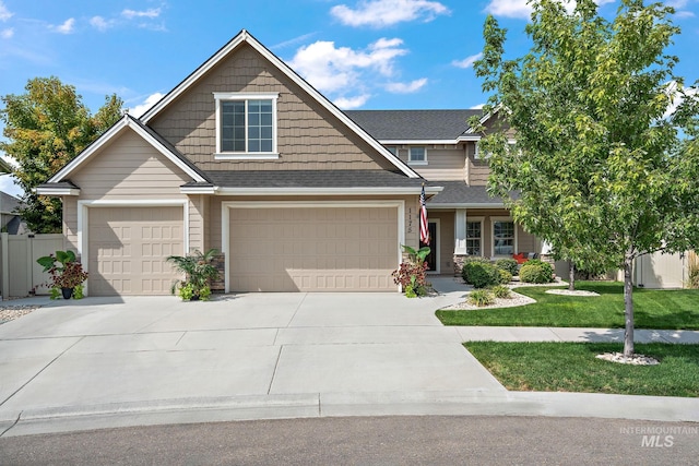 1175 N Champions Pl, Eagle, ID 83616 - craftsman-style home with fence, covered porch, a front yard, a shingled roof, and driveway