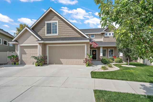 craftsman inspired home with a front yard and a garage