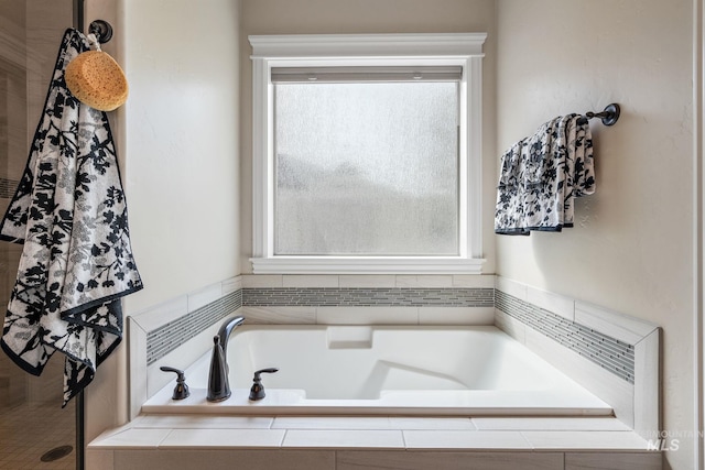 bathroom featuring tiled bath