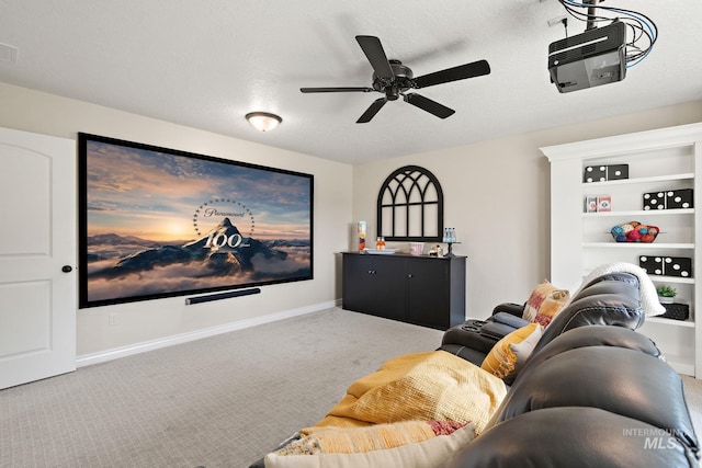 cinema room featuring a textured ceiling, ceiling fan, and carpet floors