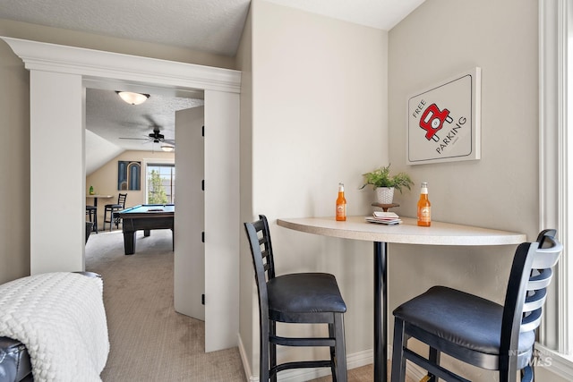 dining area with pool table, ceiling fan, vaulted ceiling, indoor bar, and light colored carpet