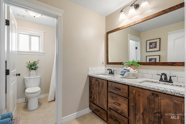 bathroom with backsplash, toilet, a textured ceiling, and vanity