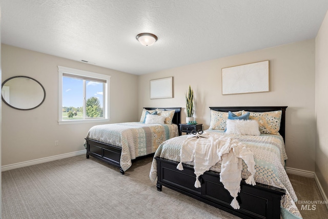 carpeted bedroom featuring a textured ceiling