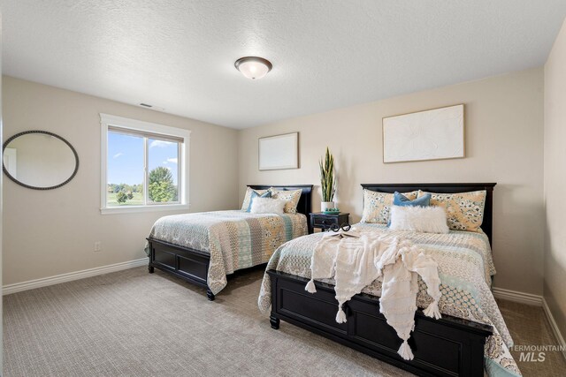 1175 N Champions Pl, Eagle, ID 83616 - carpeted bedroom featuring baseboards, a textured ceiling, and visible vents