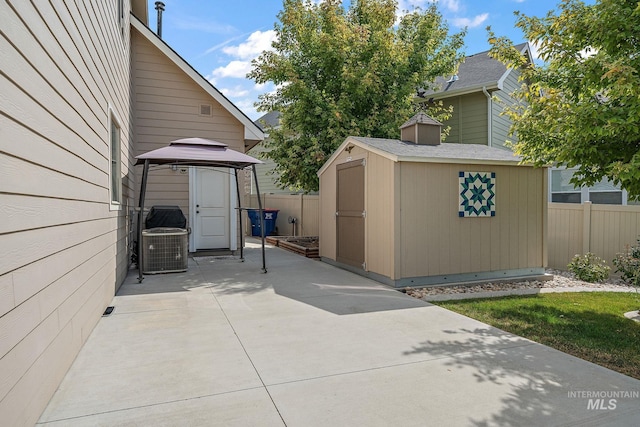 1175 N Champions Pl, Eagle, ID 83616 - view of patio / terrace with central AC, fence, a shed, a gazebo, and an outbuilding