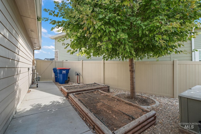 1175 N Champions Pl, Eagle, ID 83616 - view of patio / terrace with fence and a vegetable garden