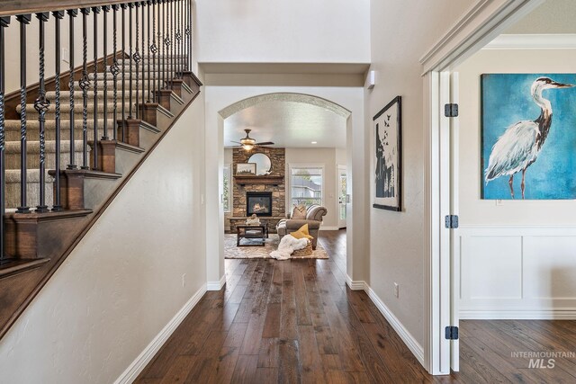 1175 N Champions Pl, Eagle, ID 83616 - hall featuring stairs, arched walkways, baseboards, and hardwood / wood-style floors