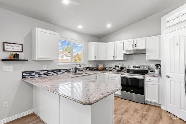 kitchen with electric stove, under cabinet range hood, a sink, a peninsula, and white cabinetry