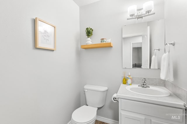 bathroom with toilet and vanity