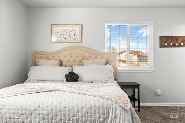 carpeted bedroom featuring baseboards