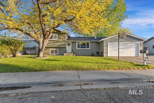tri-level home with a garage and concrete driveway