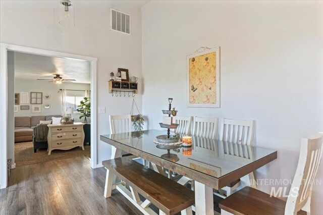 dining area with wood finished floors and a ceiling fan