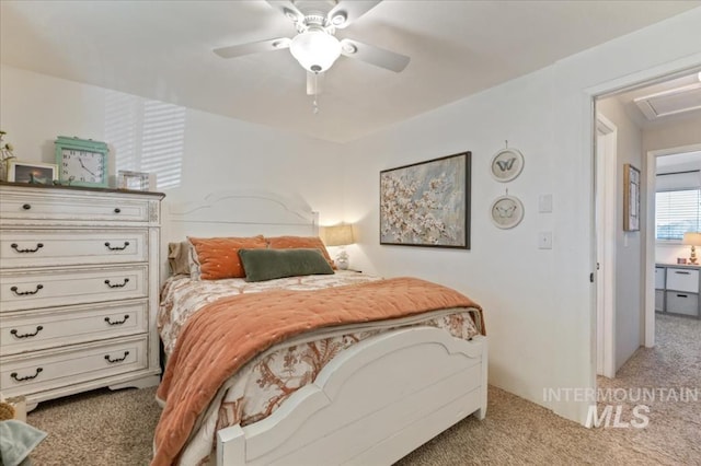 bedroom with light carpet and a ceiling fan