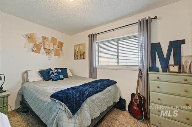 bedroom featuring a textured ceiling and carpet flooring