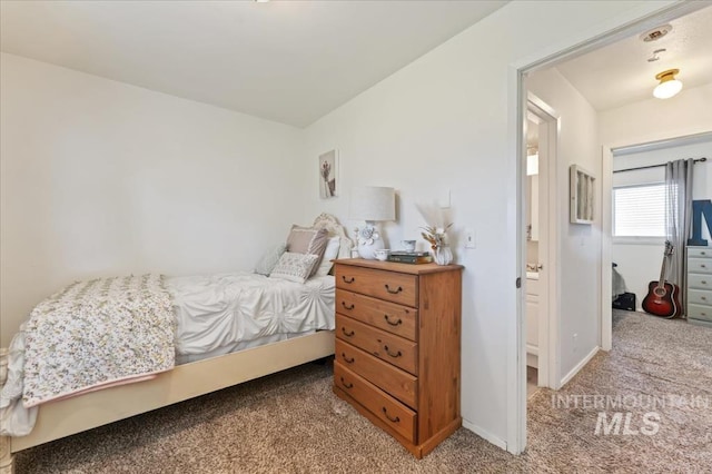 carpeted bedroom featuring baseboards