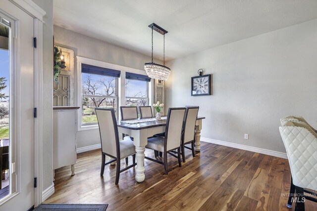 4049 Quail Ridge Dr, Kimberly, ID 83341 - dining area featuring dark wood-type flooring, an inviting chandelier, and baseboards