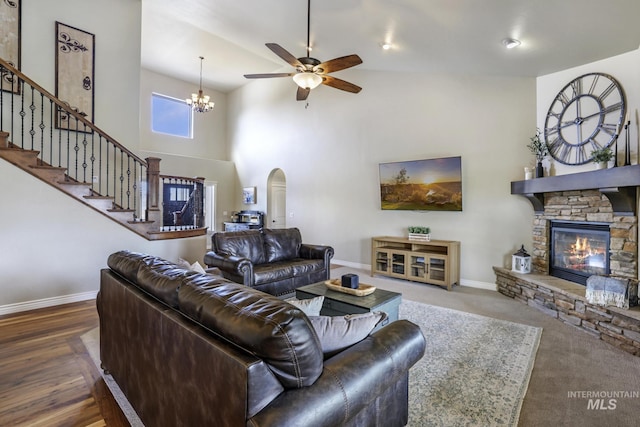 4049 Quail Ridge Dr, Kimberly, ID 83341 - living area featuring ceiling fan with notable chandelier, a fireplace, a towering ceiling, stairs, and baseboards