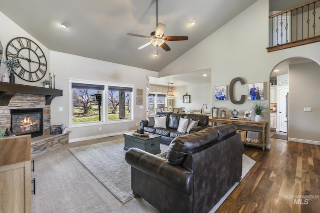 4049 Quail Ridge Dr, Kimberly, ID 83341 - living room featuring high vaulted ceiling, ceiling fan, arched walkways, a stone fireplace, and baseboards