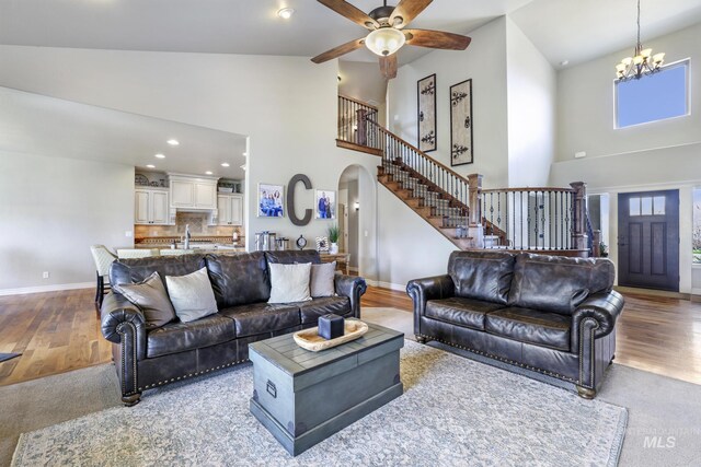 4049 Quail Ridge Dr, Kimberly, ID 83341 - living room featuring arched walkways, wood finished floors, baseboards, and stairs