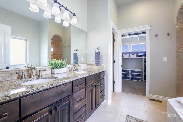4049 Quail Ridge Dr, Kimberly, ID 83341 - full bath with tile patterned floors, a walk in closet, double vanity, and a sink