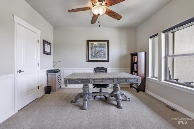 4049 Quail Ridge Dr, Kimberly, ID 83341 - office area with visible vents, a decorative wall, a ceiling fan, a wainscoted wall, and light carpet