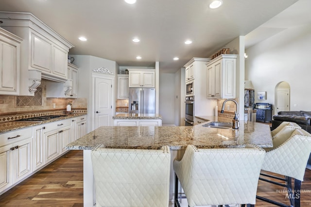 4049 Quail Ridge Dr, Kimberly, ID 83341 - kitchen with a sink, a peninsula, light stone countertops, dark wood-type flooring, and stainless steel appliances