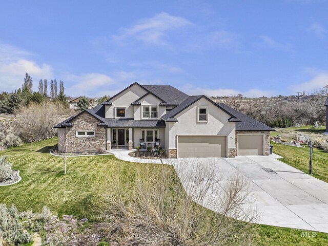 4049 Quail Ridge Dr, Kimberly, ID 83341 - view of front of house with driveway, stucco siding, stone siding, and a front yard