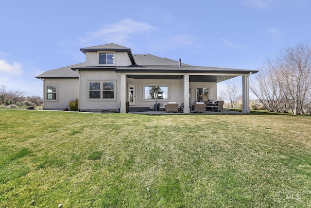 4049 Quail Ridge Dr, Kimberly, ID 83341 - rear view of property featuring roof with shingles, a yard, a patio area, and stucco siding