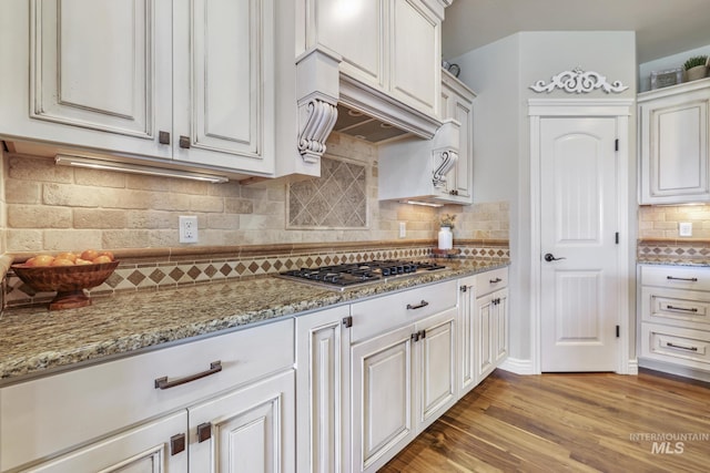 4049 Quail Ridge Dr, Kimberly, ID 83341 - kitchen with white cabinets, light wood finished floors, stainless steel gas stovetop, and light stone countertops