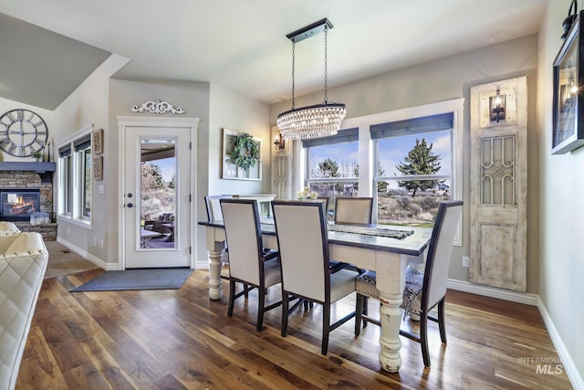 4049 Quail Ridge Dr, Kimberly, ID 83341 - dining space with a stone fireplace, plenty of natural light, a chandelier, and wood finished floors