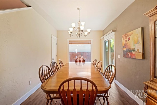 11871 W Wilmont St, Boise, ID 83709 - dining space with a chandelier, dark wood-type flooring, and baseboards