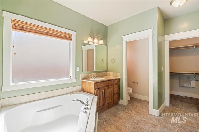 11871 W Wilmont St, Boise, ID 83709 - full bath with vanity, a garden tub, toilet, a spacious closet, and baseboards