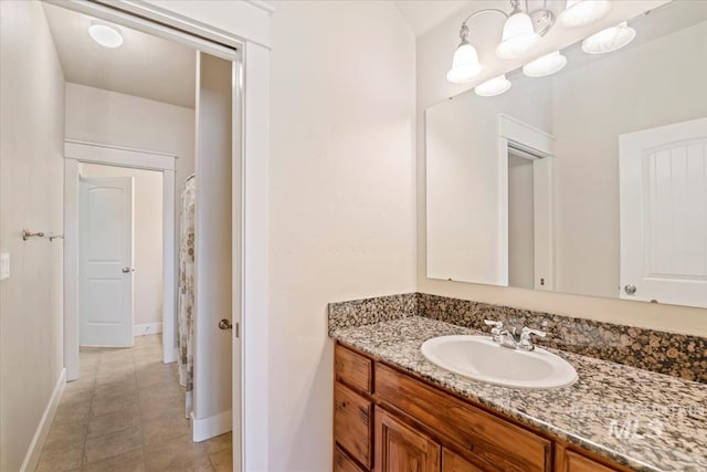 11871 W Wilmont St, Boise, ID 83709 - bathroom featuring vanity, baseboards, and tile patterned flooring